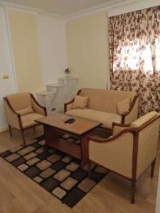 a living room with a couch and a table and chairs at Beirut Hotel Cairo in Cairo