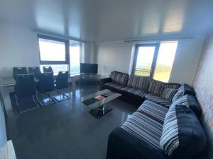 a living room with a couch and a table and chairs at Britannia Apartments in Edinburgh