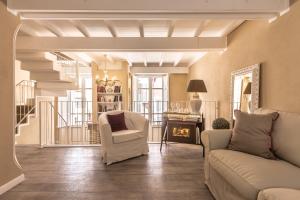 a living room with a couch and a chair and a staircase at Palazzo Dessy in Cagliari