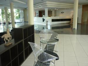 a lobby with two chairs and a counter in a building at AGH Canet in Canet de Berenguer