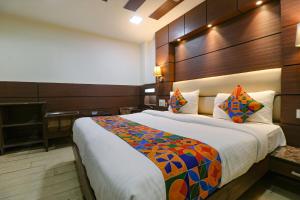 a bedroom with a large bed and a piano at FabHotel Admire Suites in New Delhi