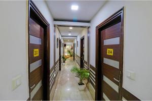 a hallway with doors and plants in a building at FabHotel Admire Suites in New Delhi