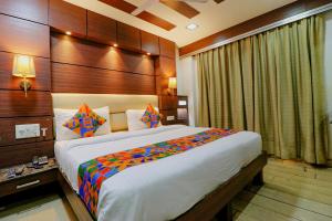 a bedroom with a large bed in a room at FabHotel Admire Suites in New Delhi