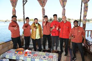 a group of men standing in front of a table at Opal privat nubian hotel in Aswan