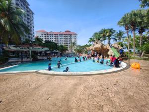 a group of people in a swimming pool at a resort at Glory beach Penthouse apartment 3bedroom in Port Dickson