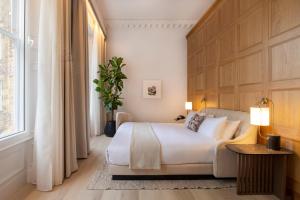 a bedroom with a large bed and a window at Virgin Hotels Edinburgh in Edinburgh