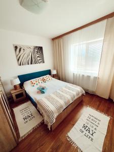 a bedroom with a bed and a window at SeaLover Apartment in Constanţa