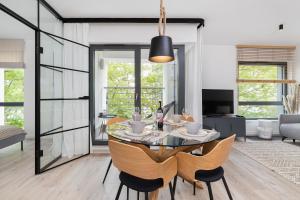 a dining room with a table and chairs at Awanport Estate Gdynia by Renters in Gdynia