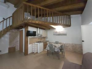 a kitchen with a staircase and a table with chairs at Appartamenti Cryfani in Pizzo
