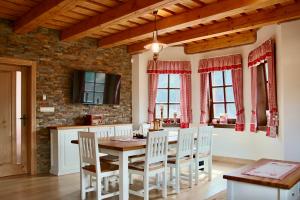 a kitchen with a table and chairs and a brick wall at Chalet Family in Horná Mariková