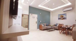 a living room with a couch and a table at شقق لمسات الخير الخيالة للشقق المخدومةAh in Riyadh