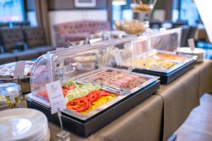 a buffet line with many different types of food at Astoria Hotel in Lviv