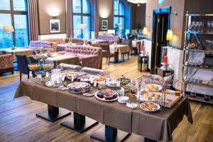 a table with plates of food on it in a restaurant at Astoria Hotel in Lviv