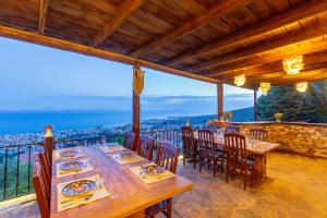 a dining room with a table and chairs on a balcony at Papazlıkhan Hotel in Altınoluk +16 photos