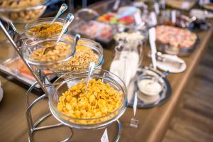 a buffet with bowls of food on a table at Astoria Hotel in Lviv