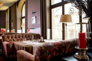 a table in a restaurant with couches and a table with a tableablish at Astoria Hotel in Lviv