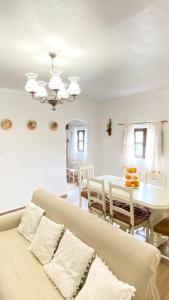 a living room with a bed and a dining room table at Celestial Melides Country House in Melides