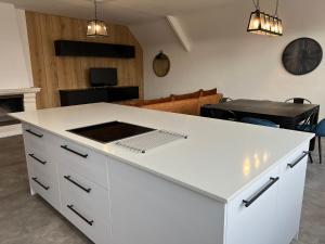 uma cozinha com uma ilha branca e um fogão em Loft ravissant entre terre et mer em Lanvollon