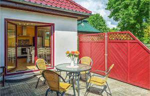 patio con tavolo, sedie e recinzione rossa di Beautiful Home In Rukieten With Wifi a Rukieten
