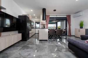a kitchen and living room with a table and chairs at Villa Blue Sky 2 ZadarVillas in Turanj
