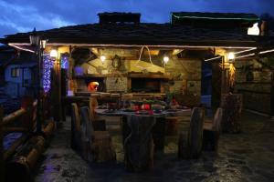 a table and chairs in front of a house at night at Guest House Shapkova Kushta in Delchevo