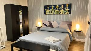 a bedroom with a bed with a table and two lamps at Luxury Allegra’s home in Syracuse