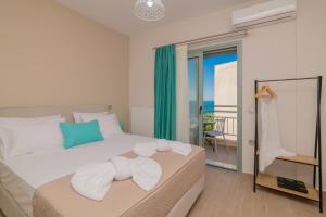 a bedroom with a bed with a view of the ocean at Emyria-Two-Floor Apartment with roof terrace in Zakynthos Town