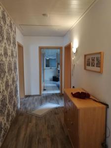 a room with a wooden dresser and a hallway at Ferienwohnung Schmidt Werratal in Wanfried