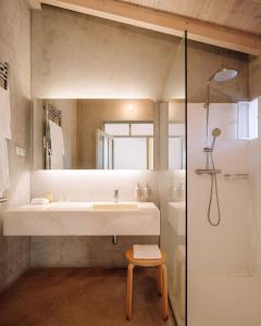 a bathroom with a large sink and a shower at Companhia das Culturas - Ecodesign & Spa Hotel in Castro Marim