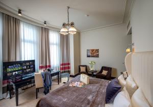 a bedroom with a bed and a living room at Astoria Hotel in Lviv +37 photos