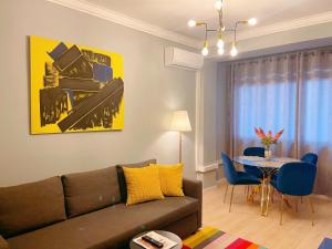 a living room with a couch and a table at Golden Beach Apartment in Cascais