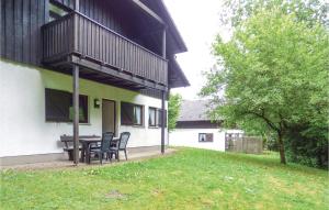a patio with chairs and a table in a yard at Ferienhaus 16 In Thalfang in Thalfang