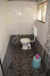 a bathroom with a toilet in a room at Hotel Gokarn Lodging in Satara