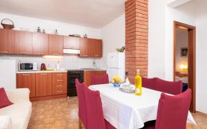 a kitchen and dining room with a table and chairs at Holiday Home Sansevic in Stari Grad
