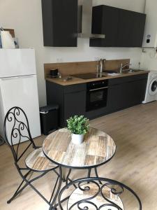 a kitchen with a table with a potted plant on it at L'étape de la Tour in Grand-Fougeray