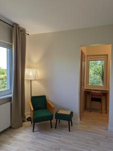 a room with a chair and a desk and a window at Provansalis in Paberžė