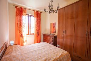 a bedroom with a bed and a dresser and a window at Casa del Duca - Goelba in San Giovanni