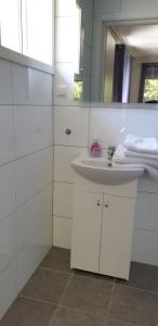 a white bathroom with a sink and a mirror at Dalen studio 3 in Dalen