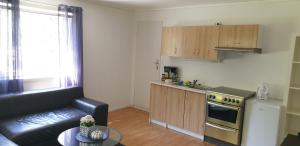 a living room with a couch and a kitchen at Dalen studio 3 in Dalen +16 photos