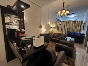 a living room with a couch and a chair at HOMESTAY SYAABAN Kamunting Taiping Batu Kurau Ulu Sepetang in Kamunting