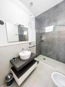 a white bathroom with a sink and a mirror at B & B Marina in Procida