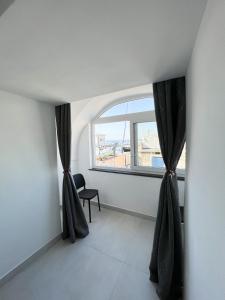 a room with a window with black curtains at B & B Marina in Procida