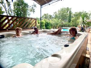 three women sitting in a jacuzzi bathtub at Villa La Rose des Vents in Tourrettes
