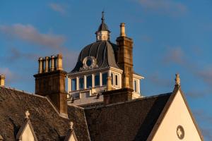 a building with a tower on top of it at Skeabost House Hotel in Portree