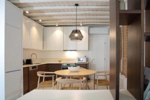 a kitchen and dining room with a table and chairs at Villa Nerea in Ornos