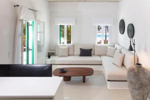 a living room with a white couch and a table at Villa Nerea in Ornos