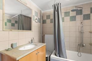 a bathroom with a sink and a shower at Dimitra's Studios in Stoupa +29 photos