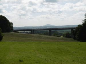 a view of a bridge from a field of grass at Ferienhof mit Bergblick in Löbau