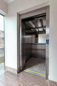 a hallway with a metal door in a building at Hotel San Rafael in Pôrto União