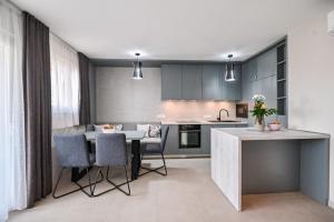 a kitchen and dining room with a table and chairs at Luxury Apartment Nina with sea view in Sveti Anton